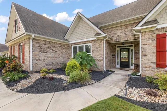a front view of a house with garden