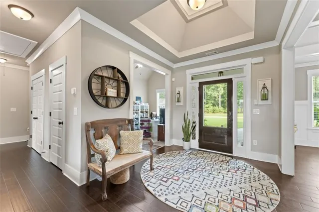 a living room with furniture a rug a lamp and a rug