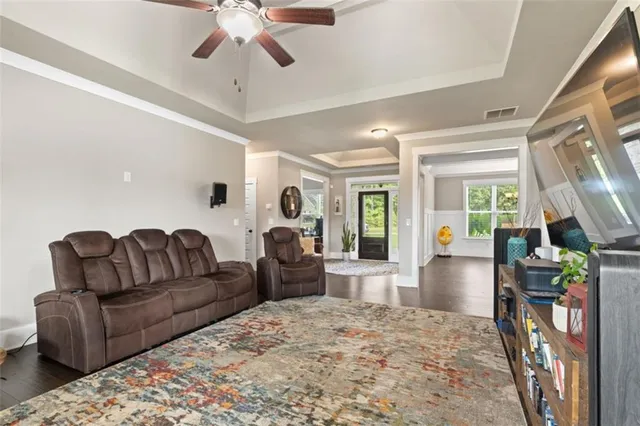 a living room with furniture a fireplace and a large window