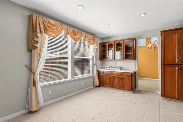 a kitchen with granite countertop wooden cabinets and stainless steel appliances