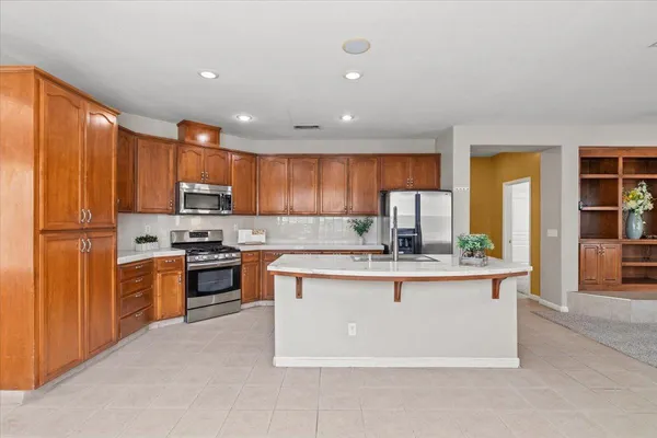 an empty room with furniture and a ceiling fan