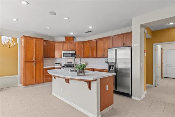 a view of an empty room with a fireplace and a window