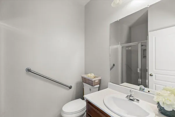 a view of a hallway with wooden cabinets