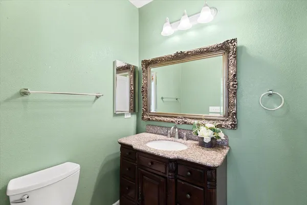 a view of a livingroom with a ceiling fan and wooden floor