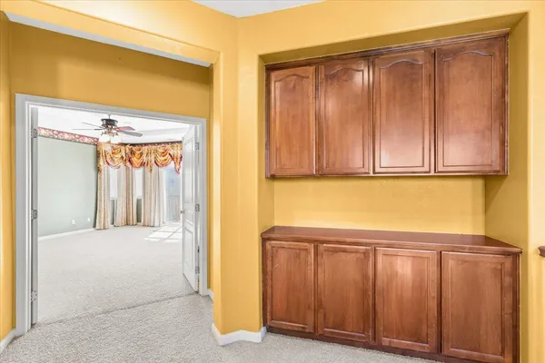 a spacious bathroom with a granite countertop sink mirror and a bathtub