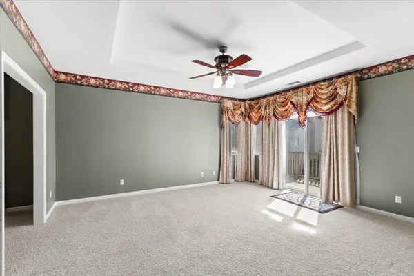an empty room with a window and a mirror