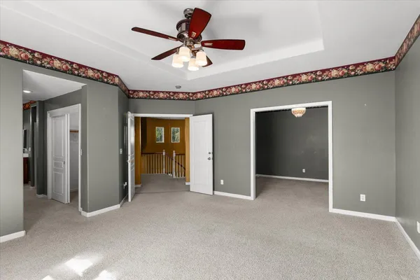 an empty room with windows and closet