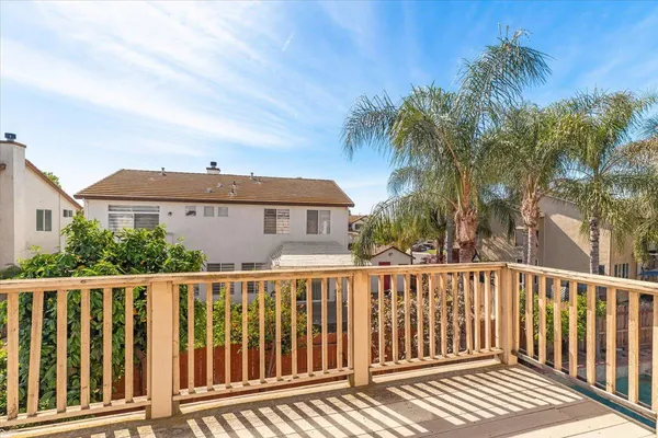 a view of a backyard with a garden and palm trees