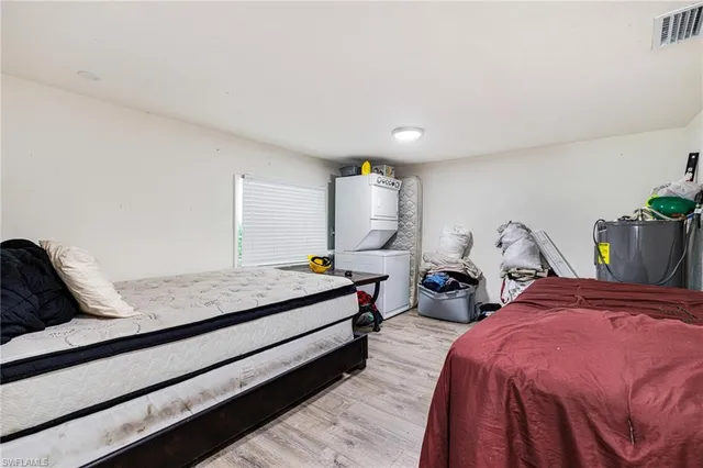 a bedroom with bed and window