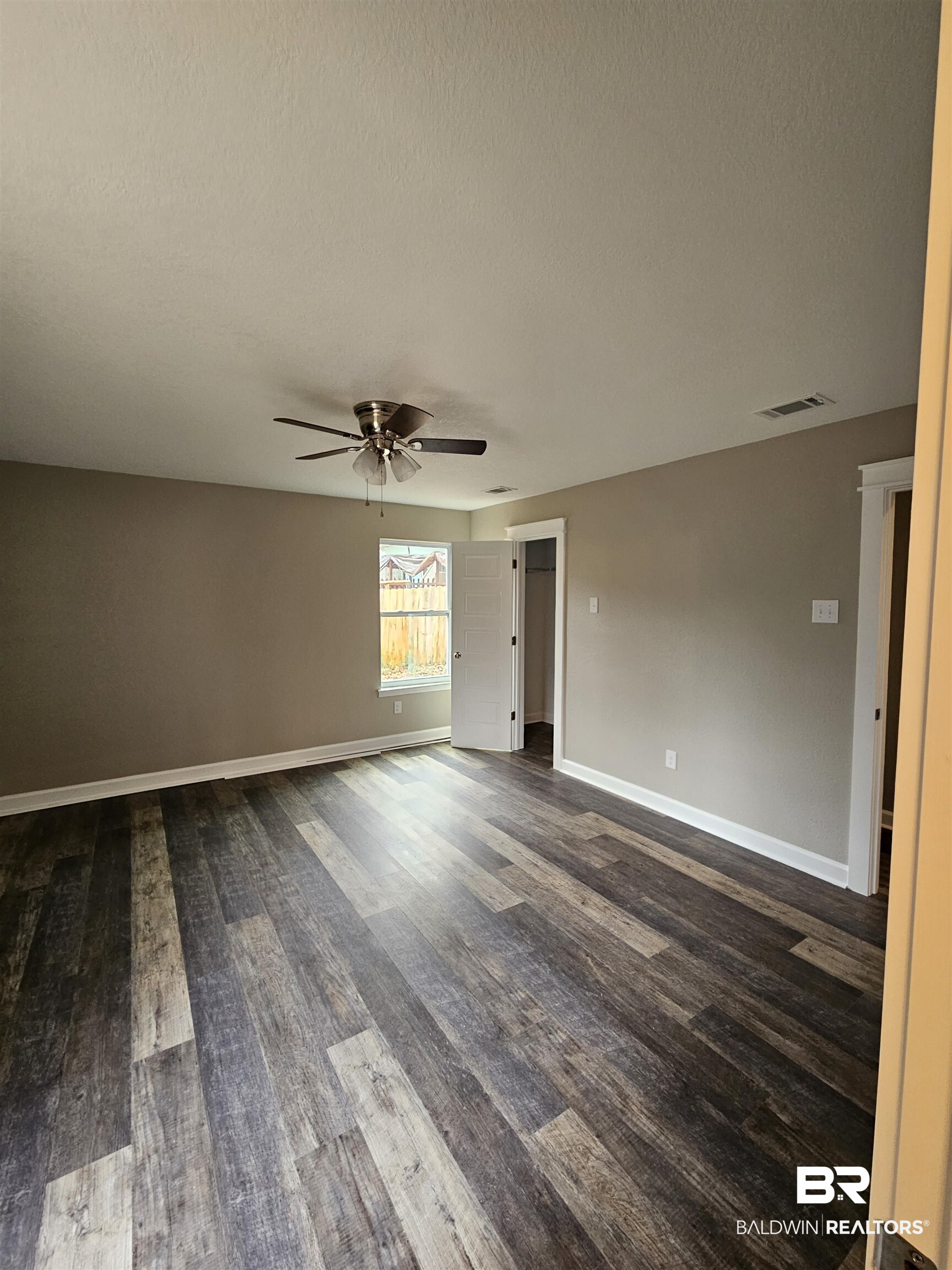 138 Wicker Way Daphne, AL 36526 - Photo 12 of 32 Unfurnished room featuring dark wood-style flooring, a ceiling fan, and a textured ceiling