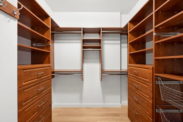 a view of walk in closet with empty racks