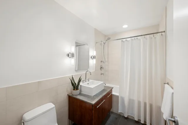 a bathroom with a sink vanity and a mirror