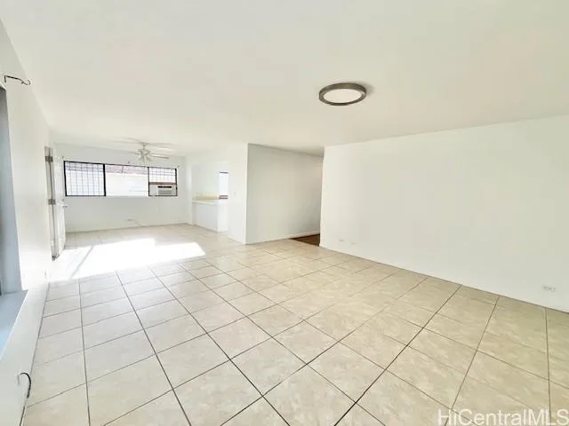 a view of a livingroom with an empty space and a window