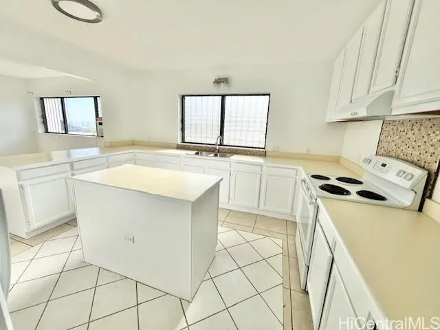 a kitchen with a stove a sink and a refrigerator