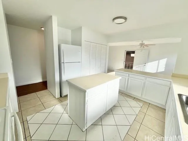 a large white kitchen with cabinets