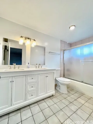 a spacious bathroom with a toilet sink and mirror