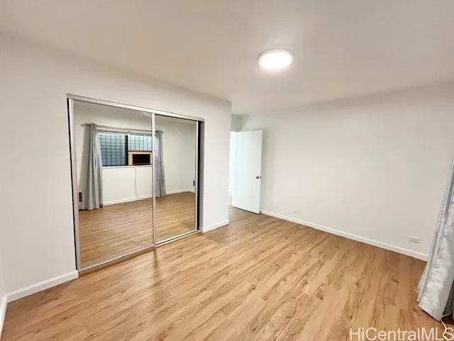 a view of an empty room and wooden floor