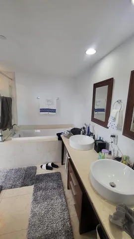 a bathroom with a double vanity sink and a mirror