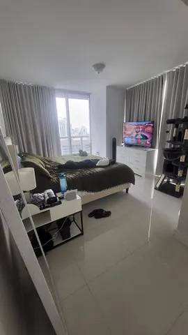 a living room with furniture a flat screen tv and a window