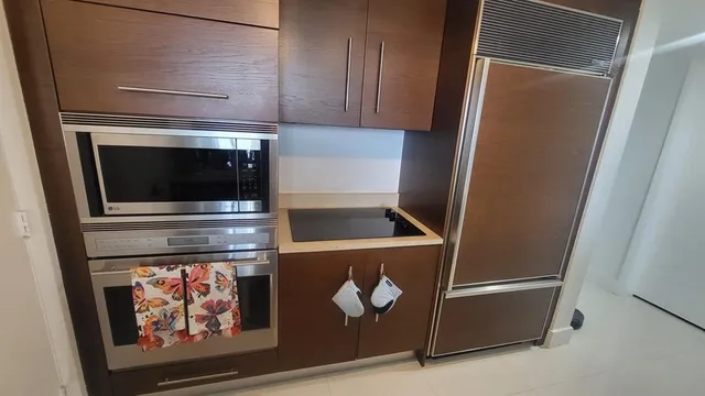 a stove top oven sitting inside of a kitchen