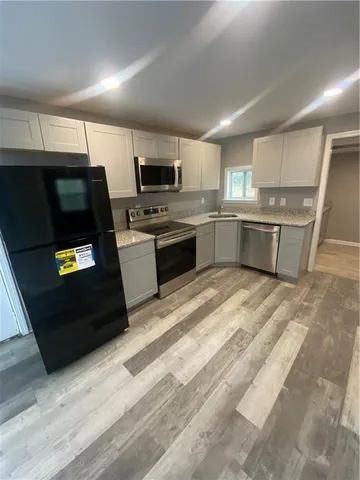 a view of a livingroom with a ceiling fan and window