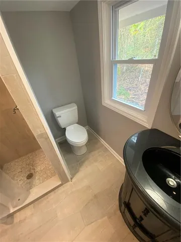 a bathroom with a sink mirror and toilet