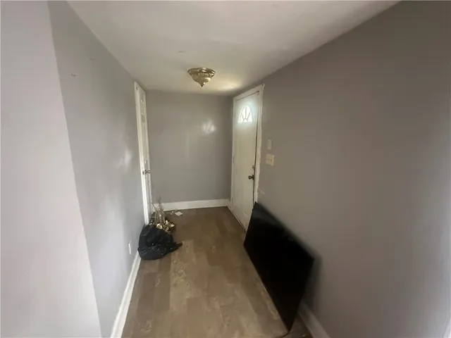 a view of hallway with a large mirror and a shower