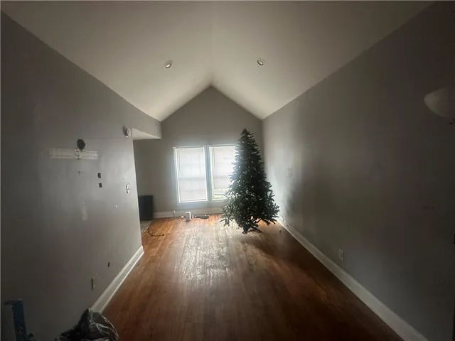 a view of an empty room and wooden floor