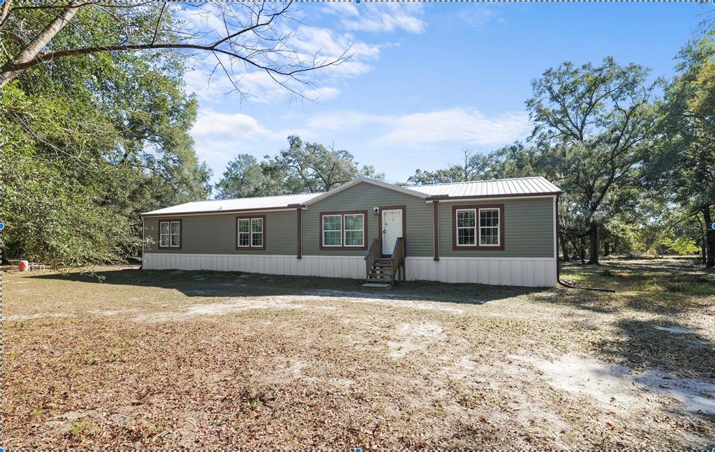 18625 Deason Drive Spring Hill, FL 34610 - Photo 1 of 35 a view of a house with a yard