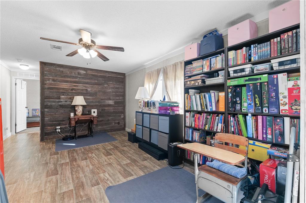 18625 Deason Drive Spring Hill, FL 34610 - Photo 12 of 35 a room with furniture and a book shelf