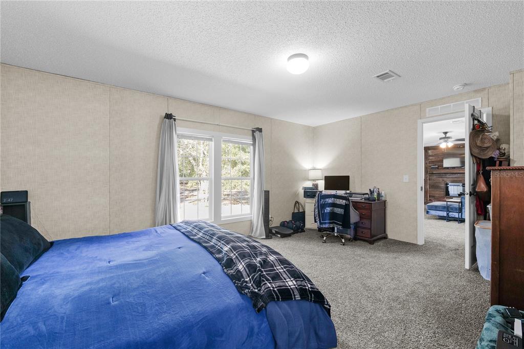 18625 Deason Drive Spring Hill, FL 34610 - Photo 14 of 35 a bedroom with a bed and furniture