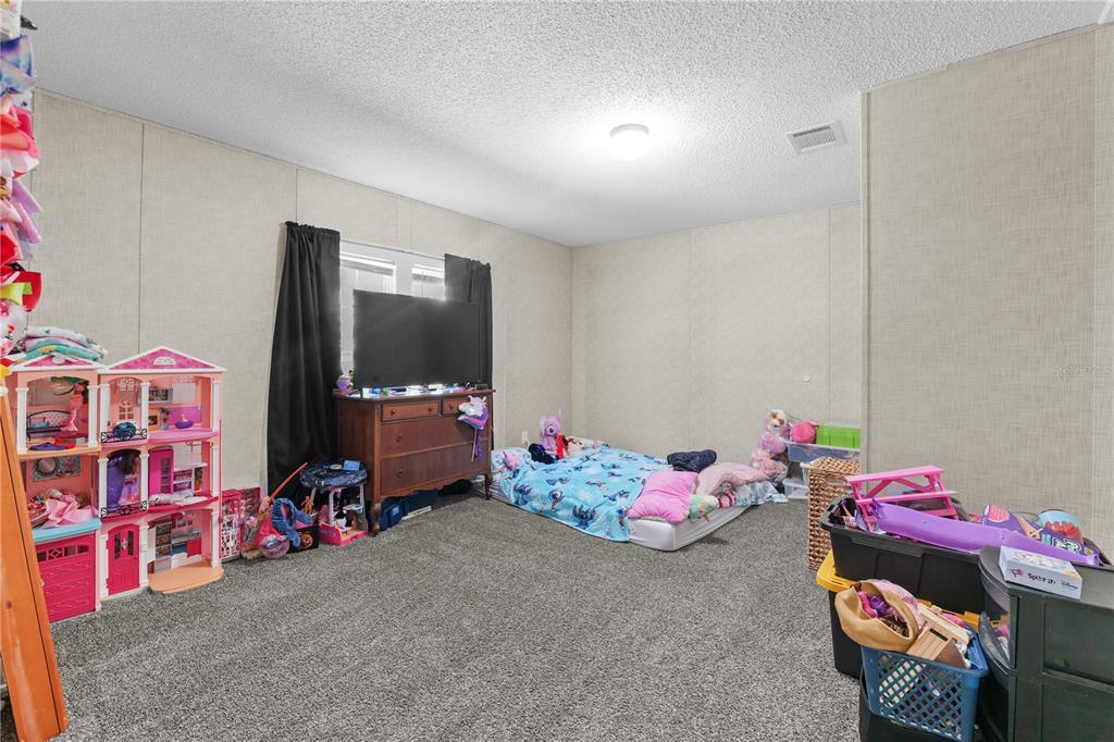 18625 Deason Drive Spring Hill, FL 34610 - Photo 20 of 35 a bedroom with baby toys and toys
