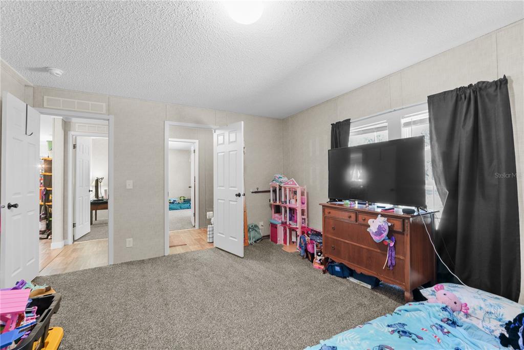 18625 Deason Drive Spring Hill, FL 34610 - Photo 21 of 35 a living room with furniture and a flat screen tv