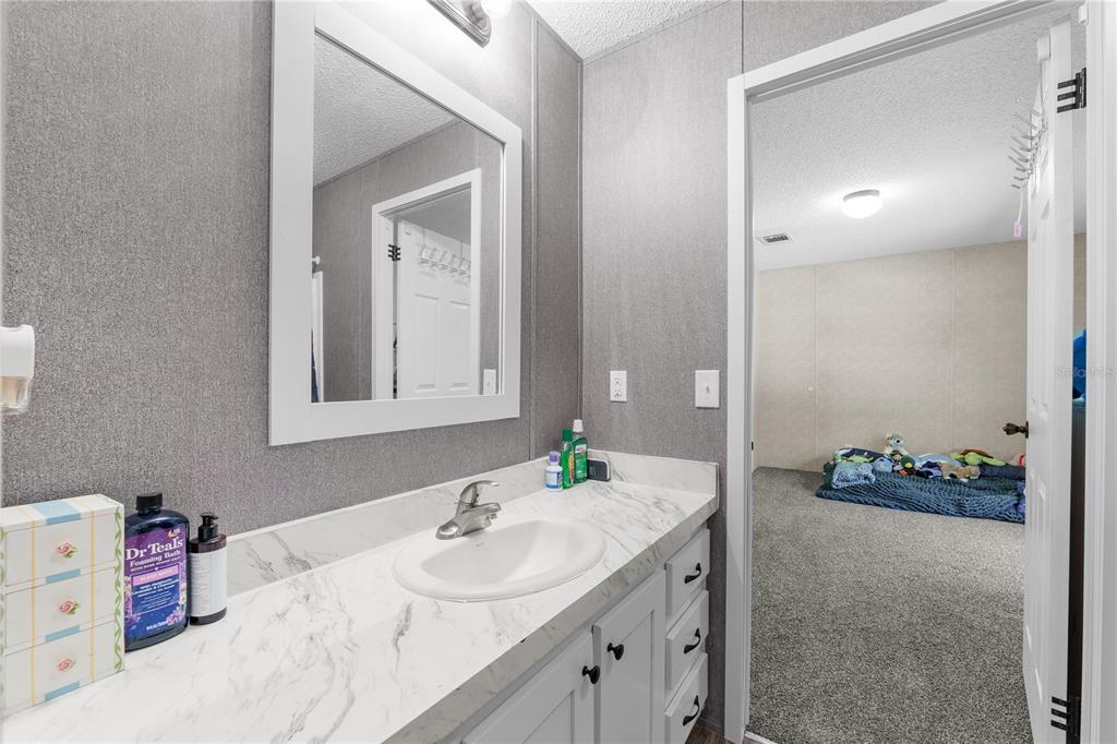 18625 Deason Drive Spring Hill, FL 34610 - Photo 22 of 35 a bathroom with a sink and a mirror