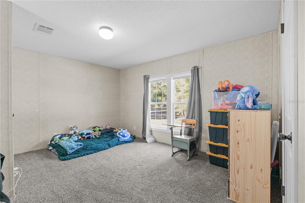 18625 Deason Drive Spring Hill, FL 34610 - Photo 24 of 35 a bed room with a bed and a window