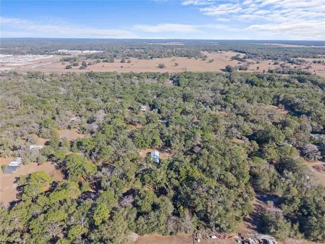 an aerial view of a houses with a yard