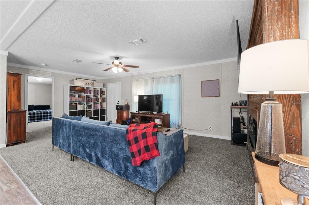 18625 Deason Drive Spring Hill, FL 34610 - Photo 5 of 35 a living room with furniture and a flat screen tv