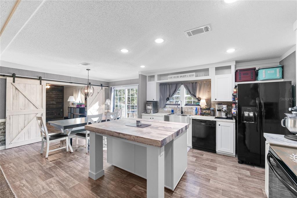 18625 Deason Drive Spring Hill, FL 34610 - Photo 6 of 35 a kitchen with refrigerator and cabinets