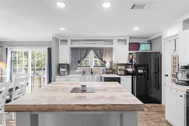 a kitchen with refrigerator and window