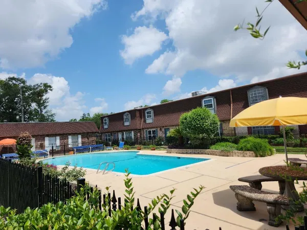 a view of a house with garden and a sitting area