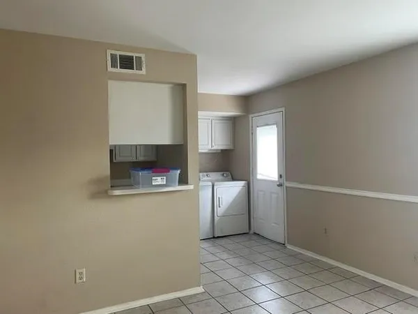 a kitchen with a refrigerator and a sink