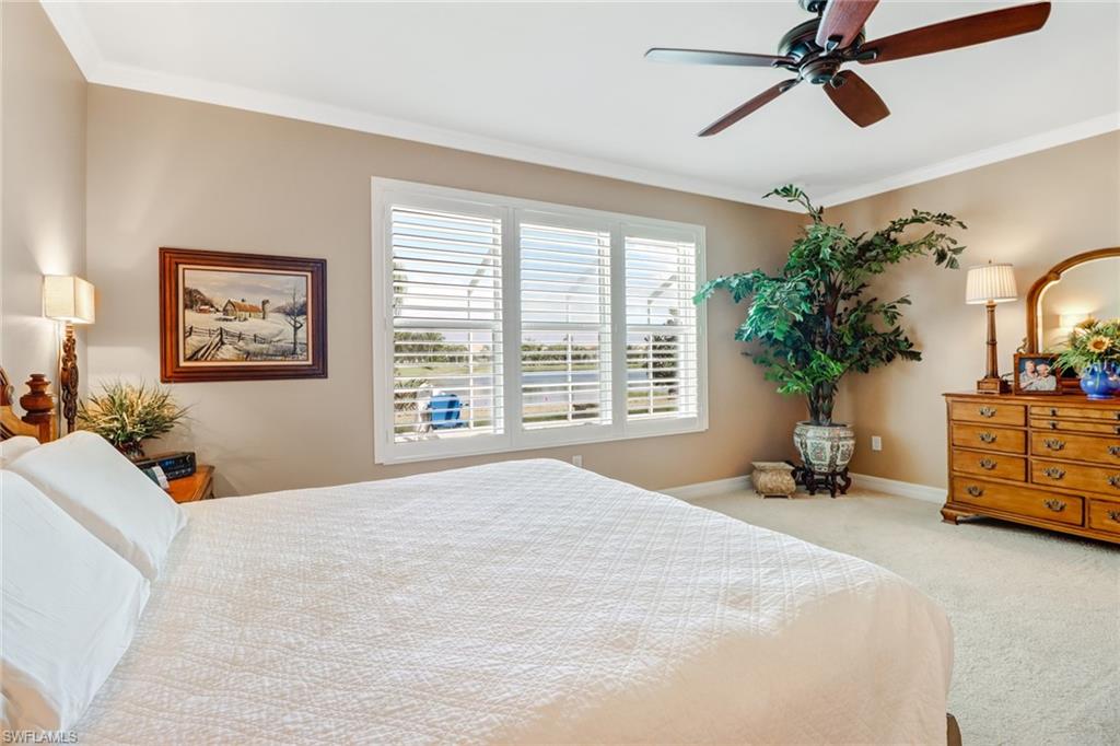 8633 Julia Lane Naples, FL 34114 - Photo 11 of 26 a bedroom with a bed couch and a window