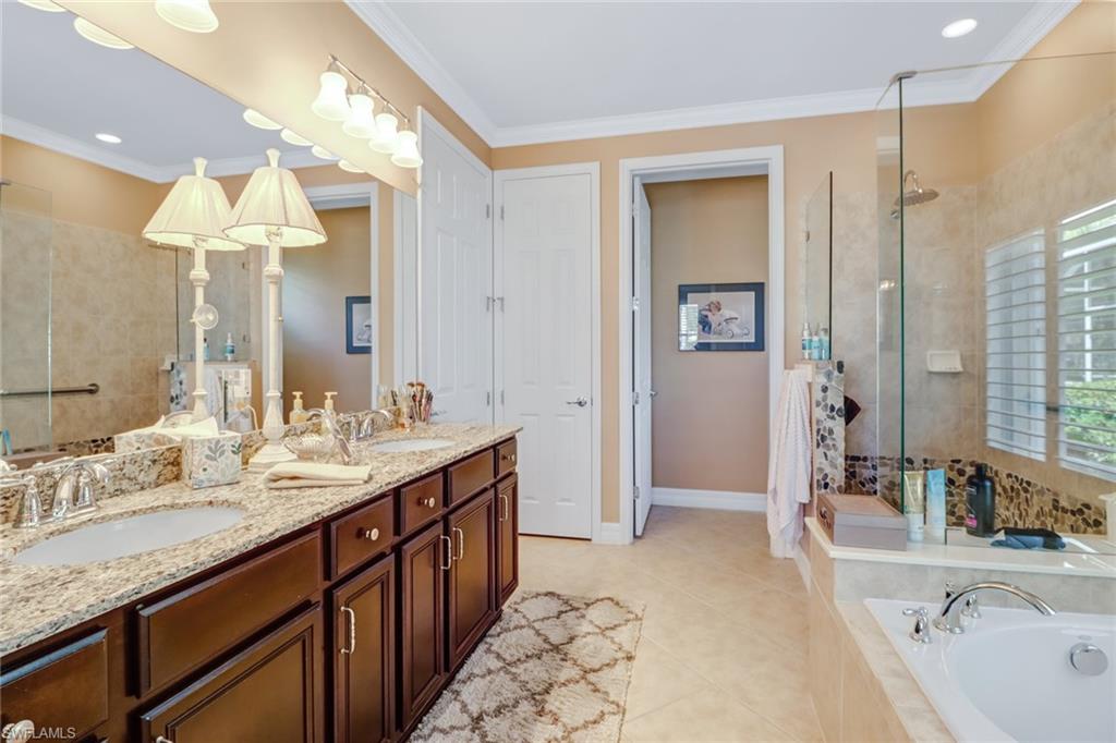 8633 Julia Lane Naples, FL 34114 - Photo 12 of 26 a spacious bathroom with a sink double vanity and a mirror