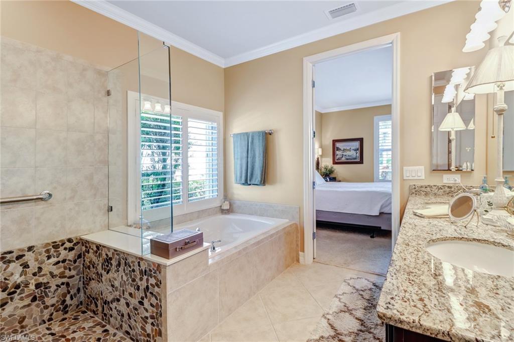 8633 Julia Lane Naples, FL 34114 - Photo 13 of 26 a spacious bedroom with a bed and a couch
