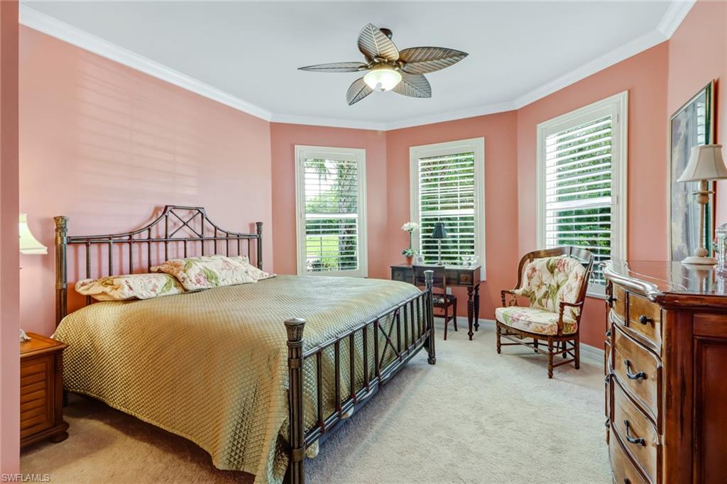 8633 Julia Lane Naples, FL 34114 - Photo 15 of 26 a bedroom with a bed chair and a chandelier