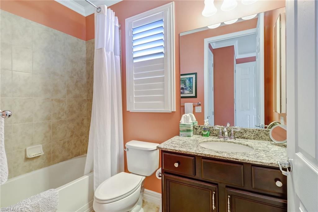 8633 Julia Lane Naples, FL 34114 - Photo 16 of 26 a bathroom with a granite countertop sink toilet and shower