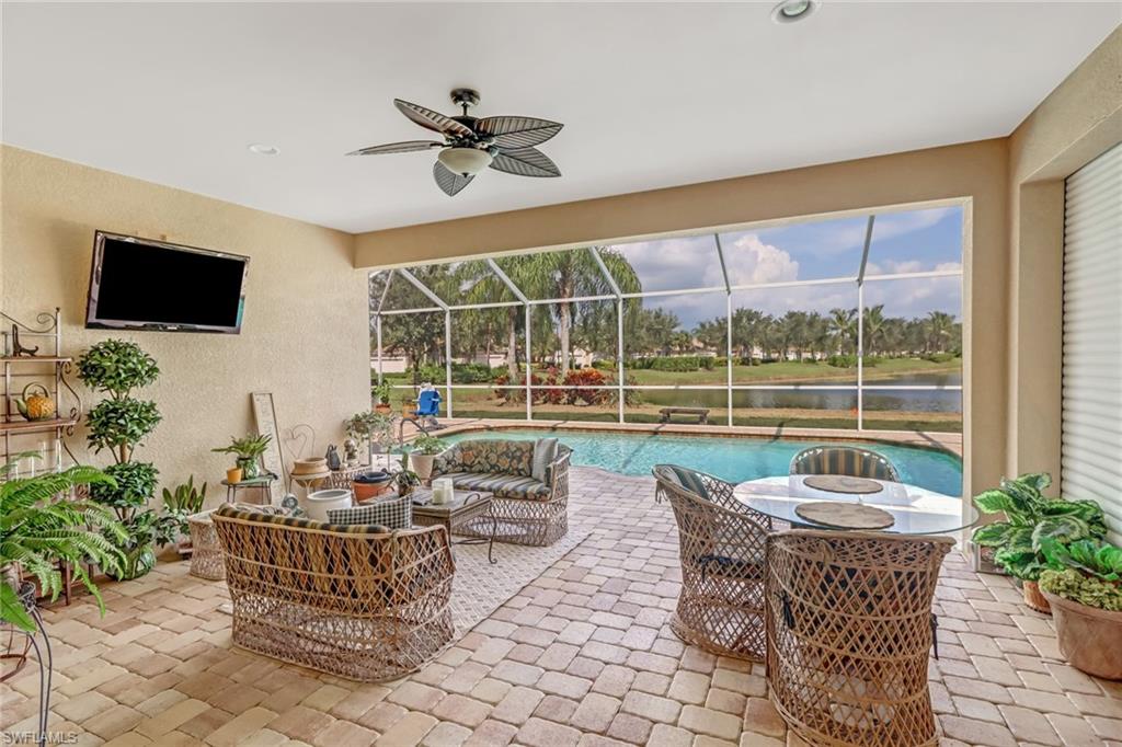 8633 Julia Lane Naples, FL 34114 - Photo 24 of 26 a living room with patio furniture and a potted plants