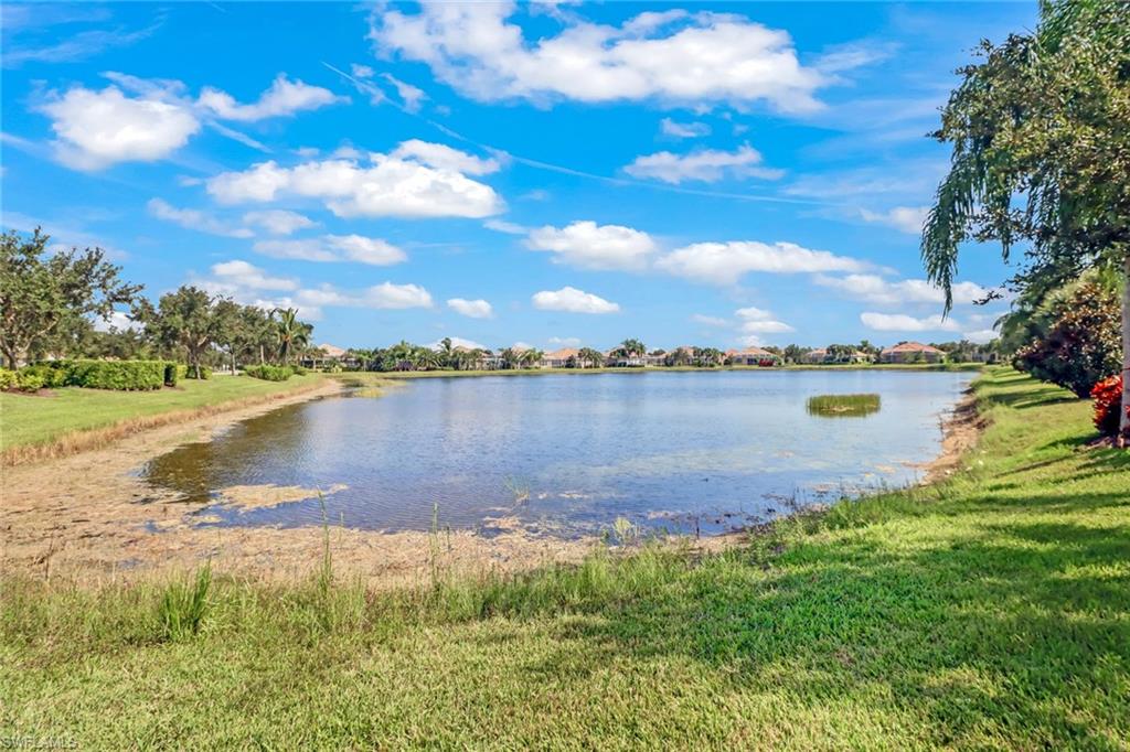 8633 Julia Lane Naples, FL 34114 - Photo 25 of 26 a view of a lake with houses in the back