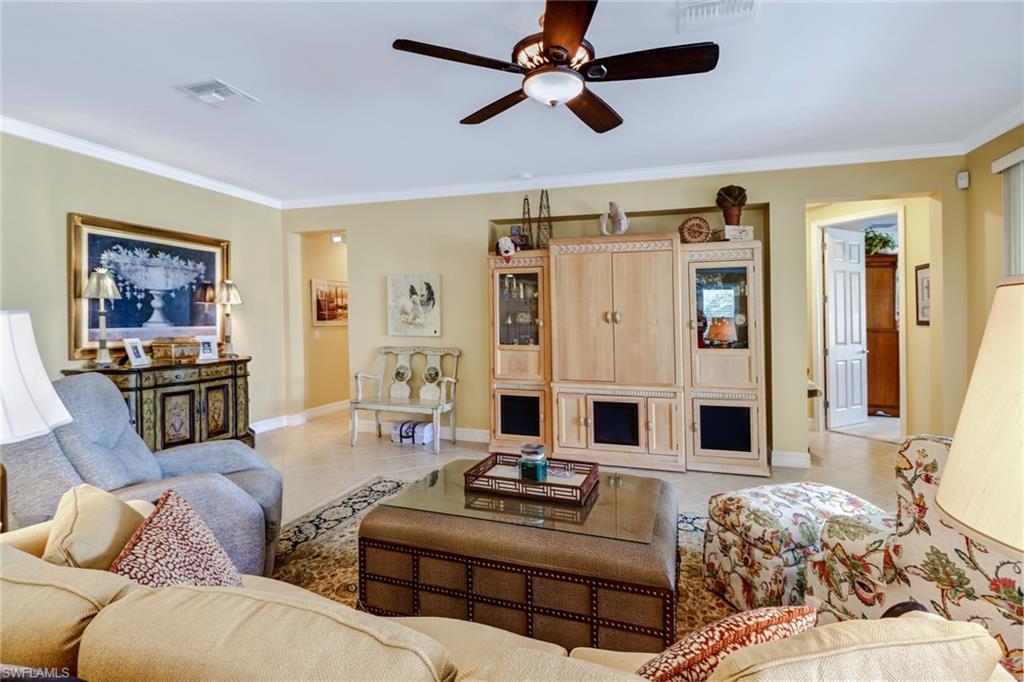 8633 Julia Lane Naples, FL 34114 - Photo 7 of 26 a living room with furniture ceiling fan and a rug