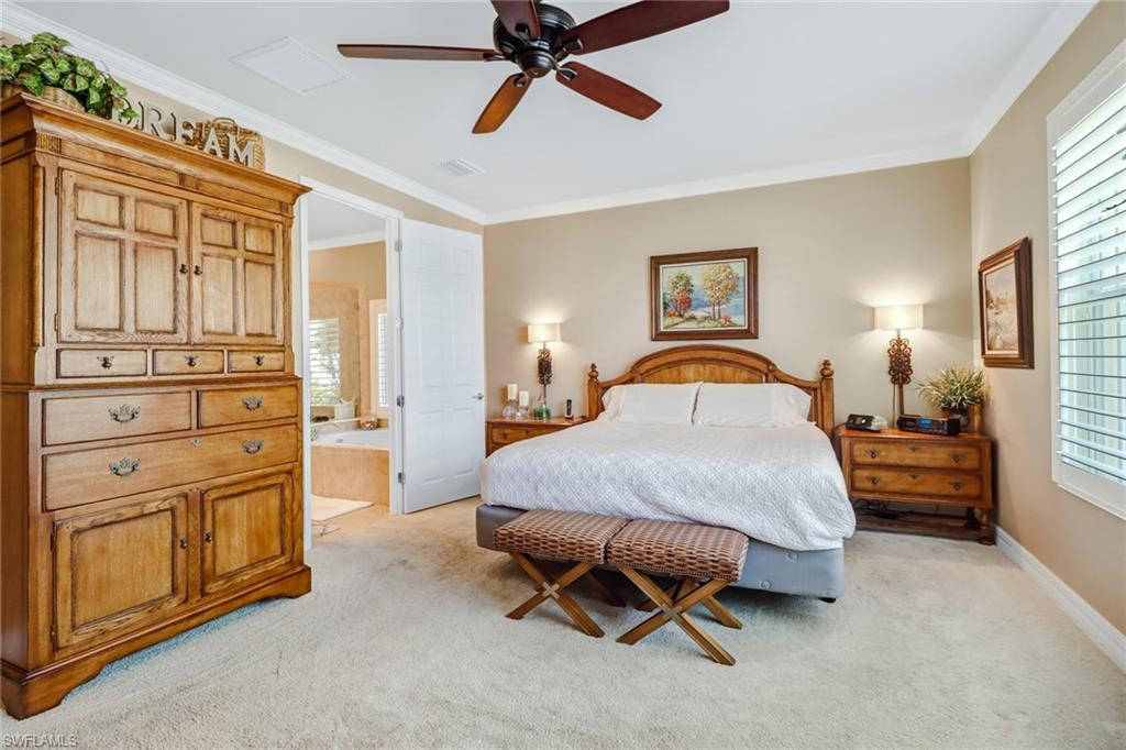 8633 Julia Lane Naples, FL 34114 - Photo 10 of 26 a spacious bedroom with a bed and dresser